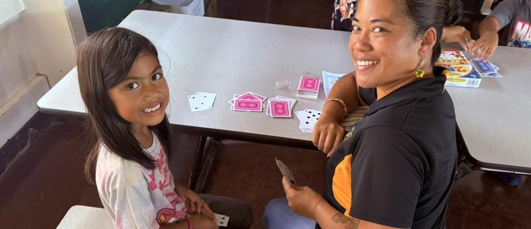 Student engaging in math games with her mom