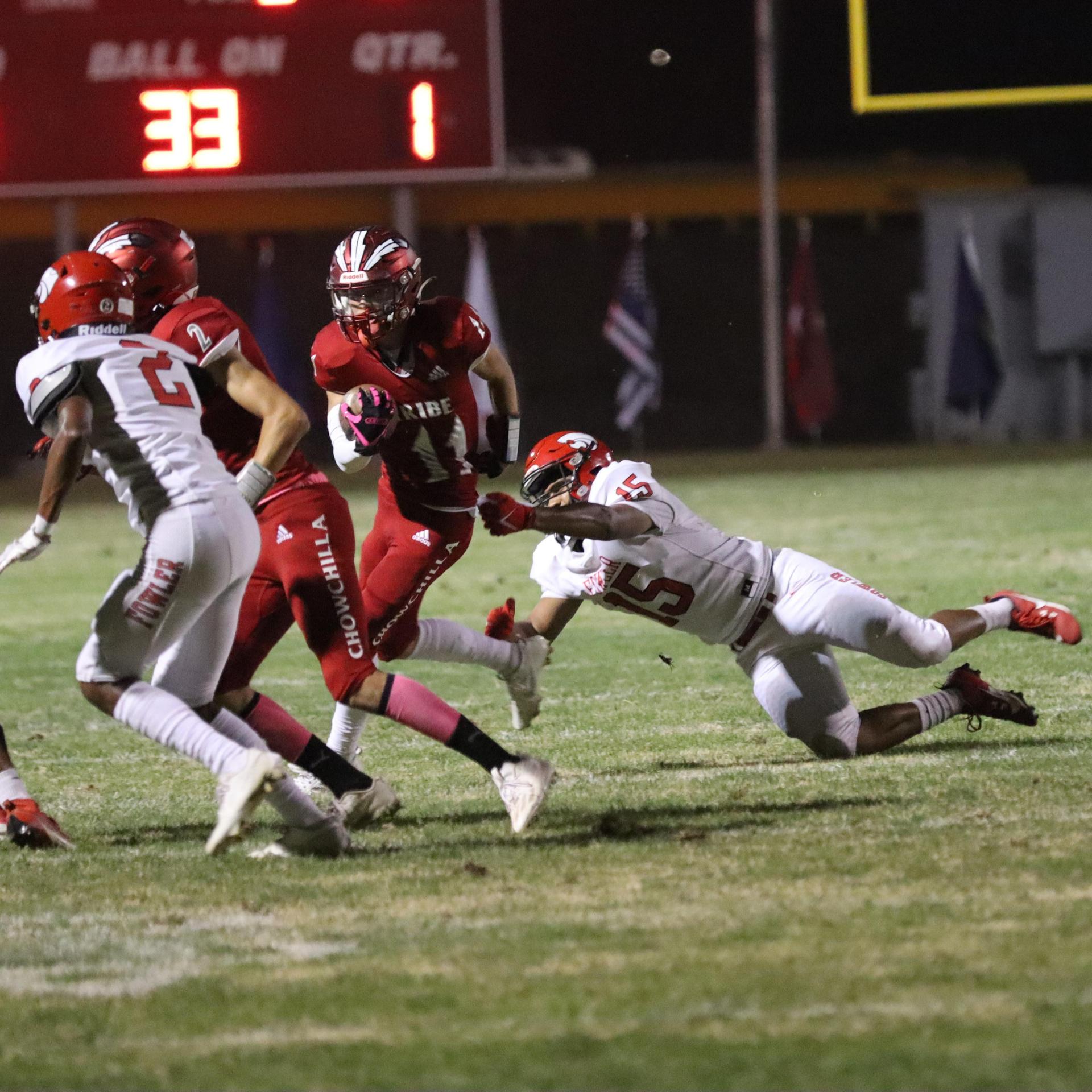 varsity boys playing football against Fowler