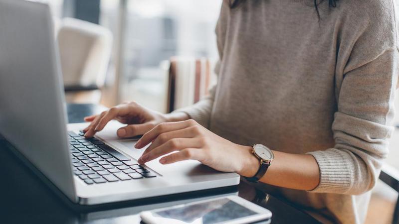 Typing on a laptop