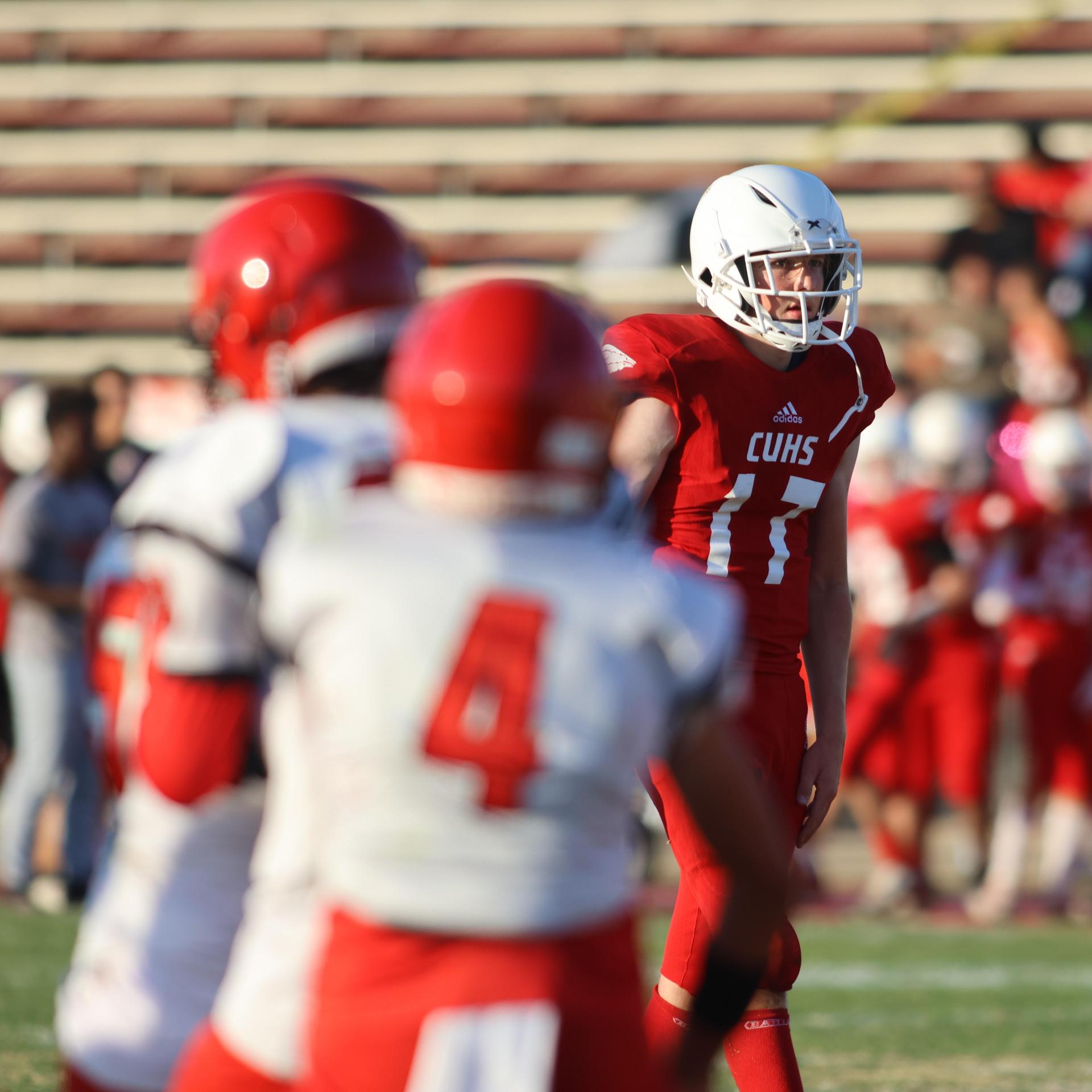 junior varsity football players in action against Fowler