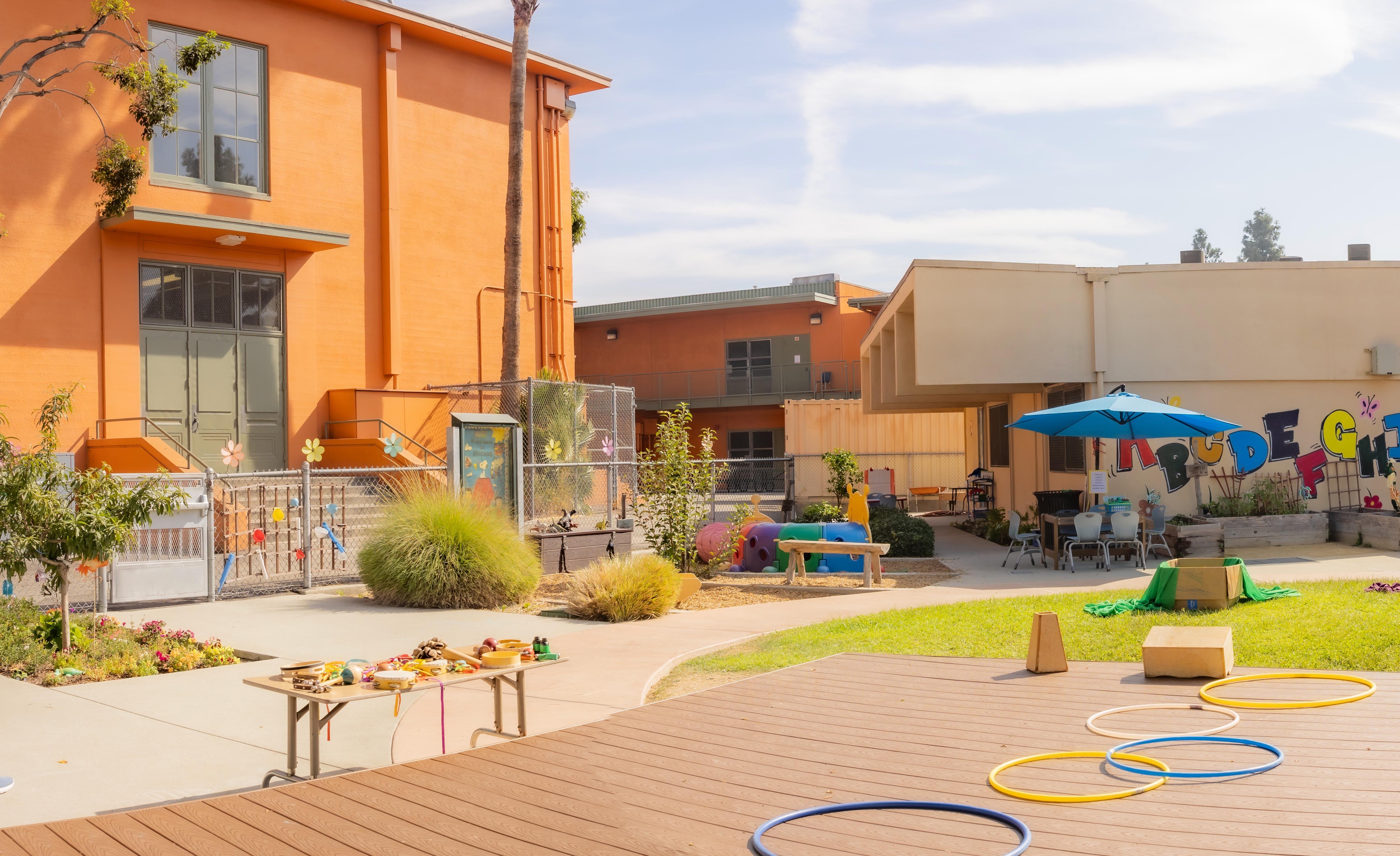 School courtyard between buildings filled with activities and toys