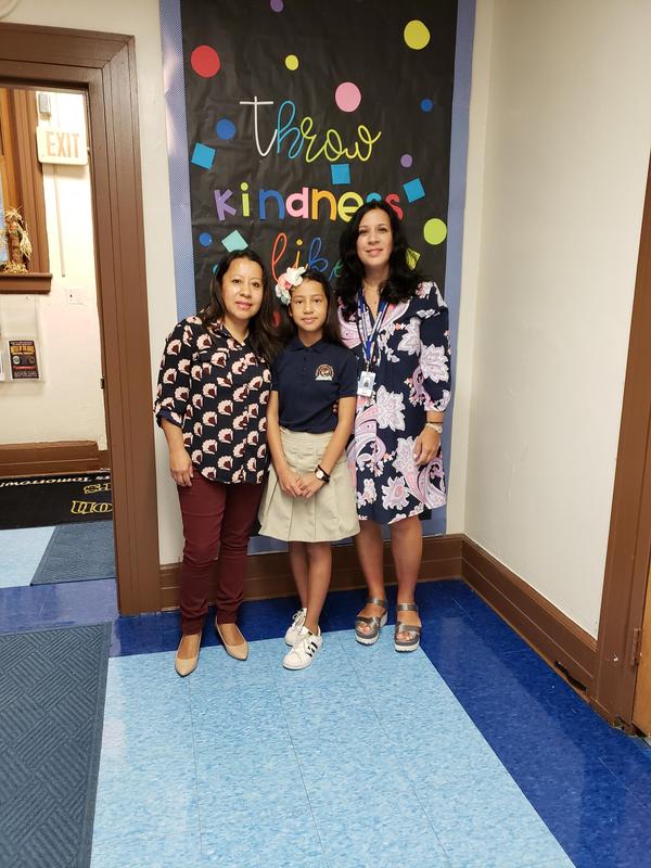 Isabella with her mom and Ms. L with a perfect PARCC math score