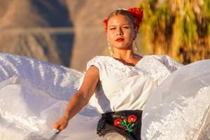 girl in white dress performing a cultural dance