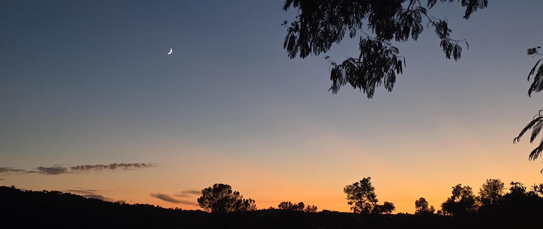 Sunset with a crescent moon