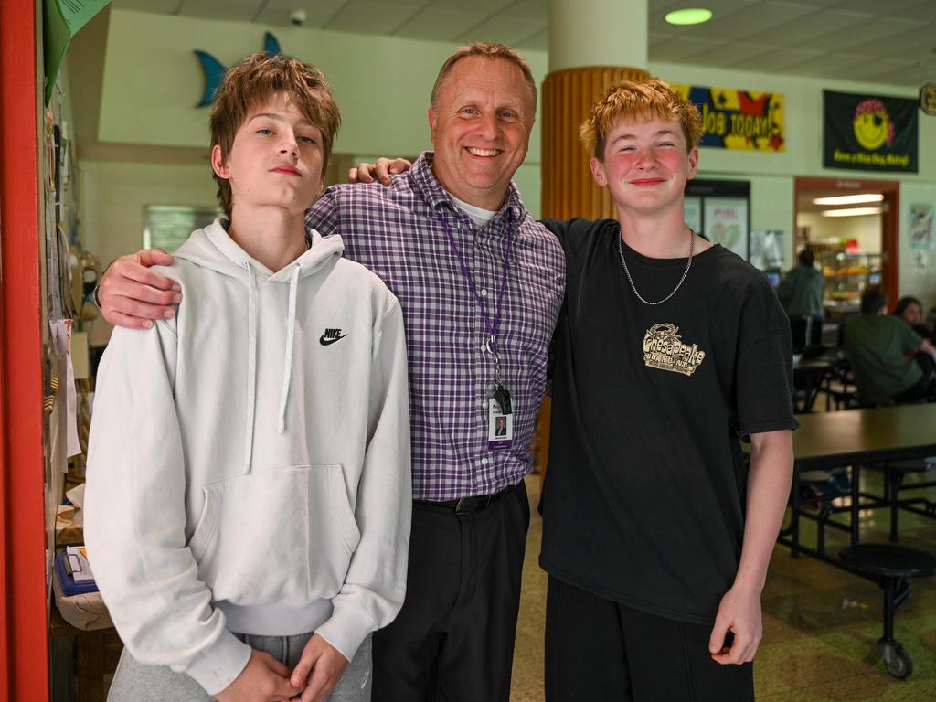 Dr. Scheibenhofer with two students in the cafeteria.