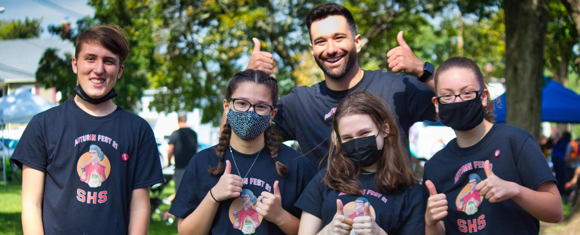 Staff and students give a