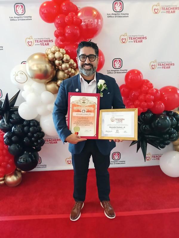 Gerardo Gomez receives recognition at the LACOE Teacher of the Year Luncheon Event