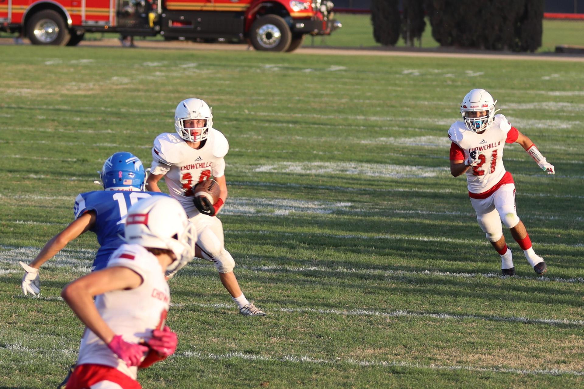 Junior Varsity football players in action against Caruthers