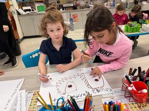 Two girls working together on their fire safety poster