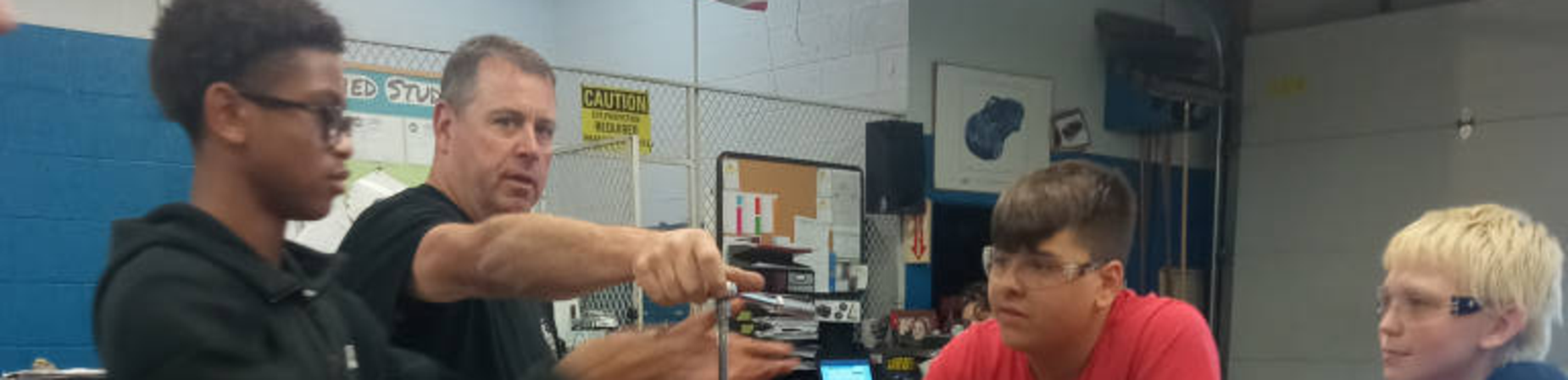 teacher teaching auto shop