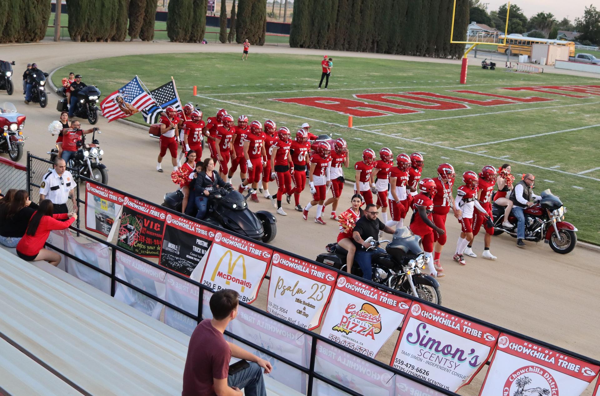 students, staff, and community members enjoying Friday night at the football game
