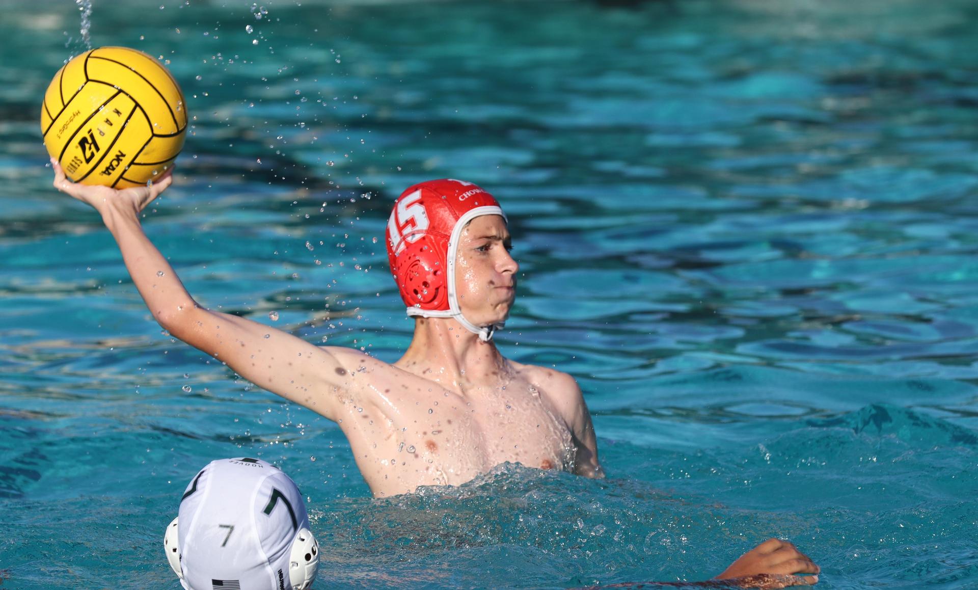 boys water polo players in action against hoover