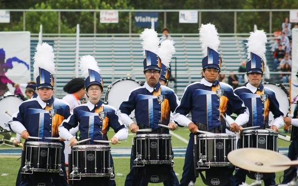 Norwin Band Drumline playing on the football field.