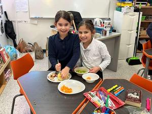 Second grade girls making tu beshvat fruit salads.