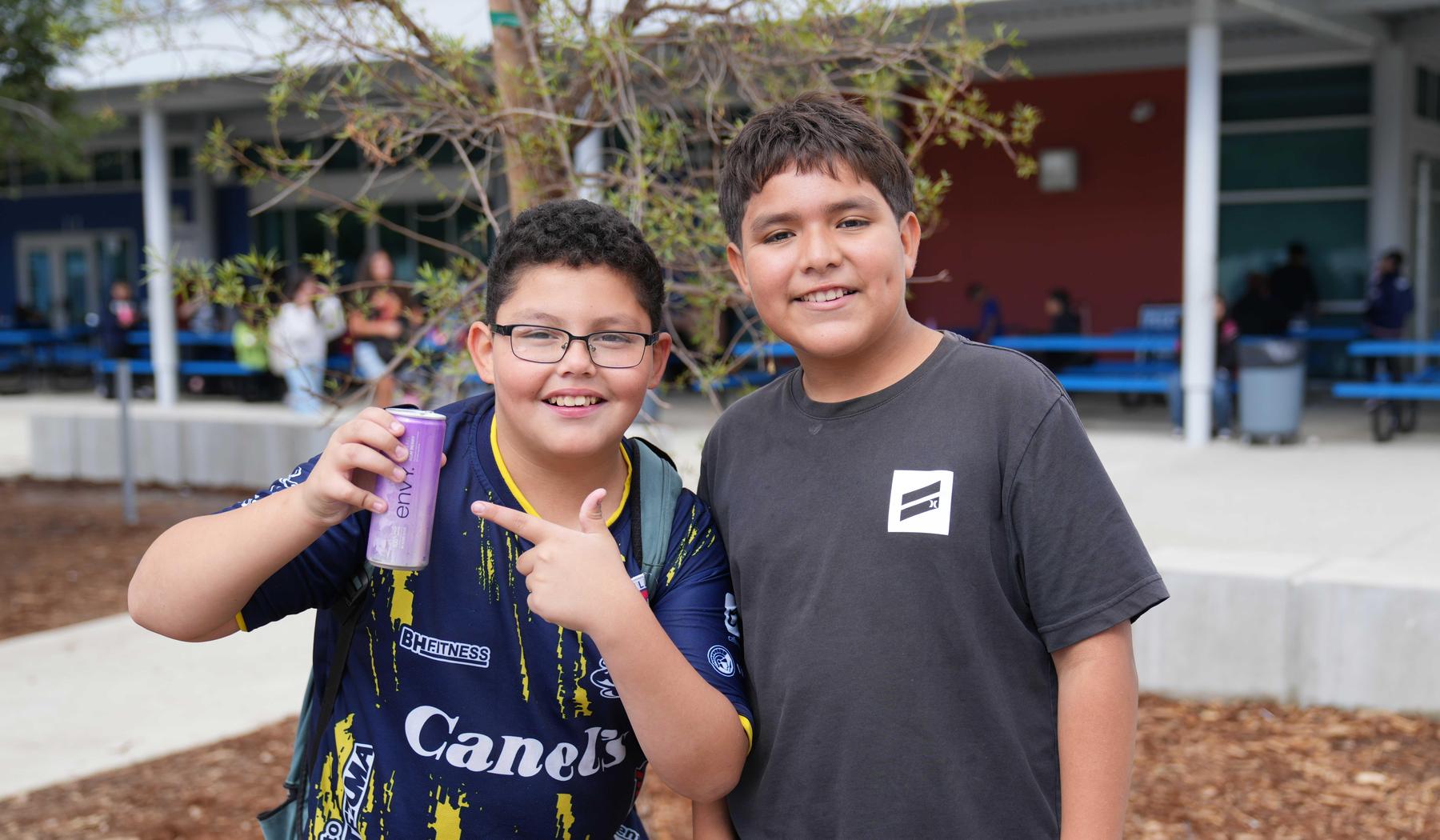two boys, one with a can of Acai Berry drink at MVMS
