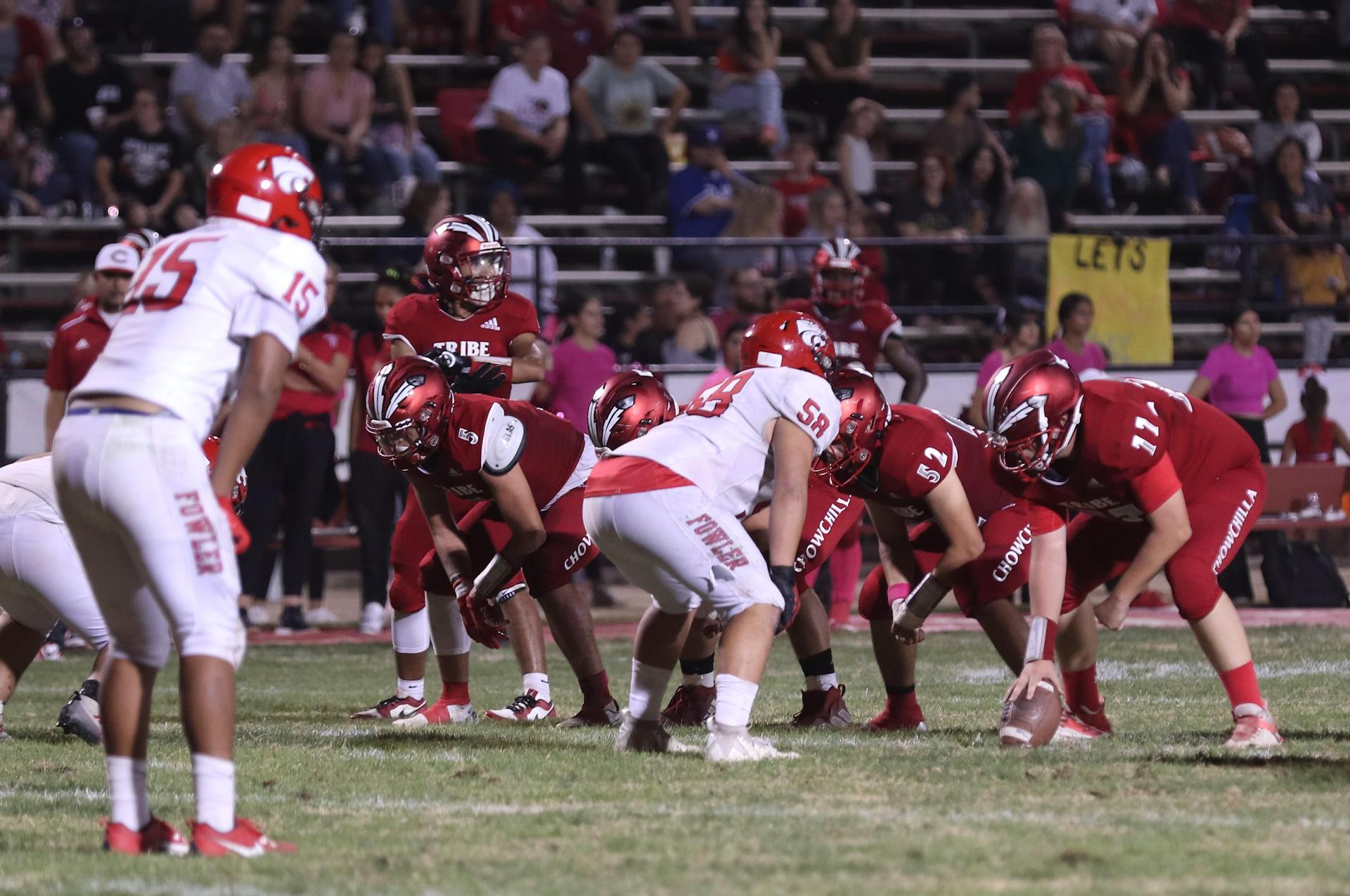 varsity boys playing football against Fowler