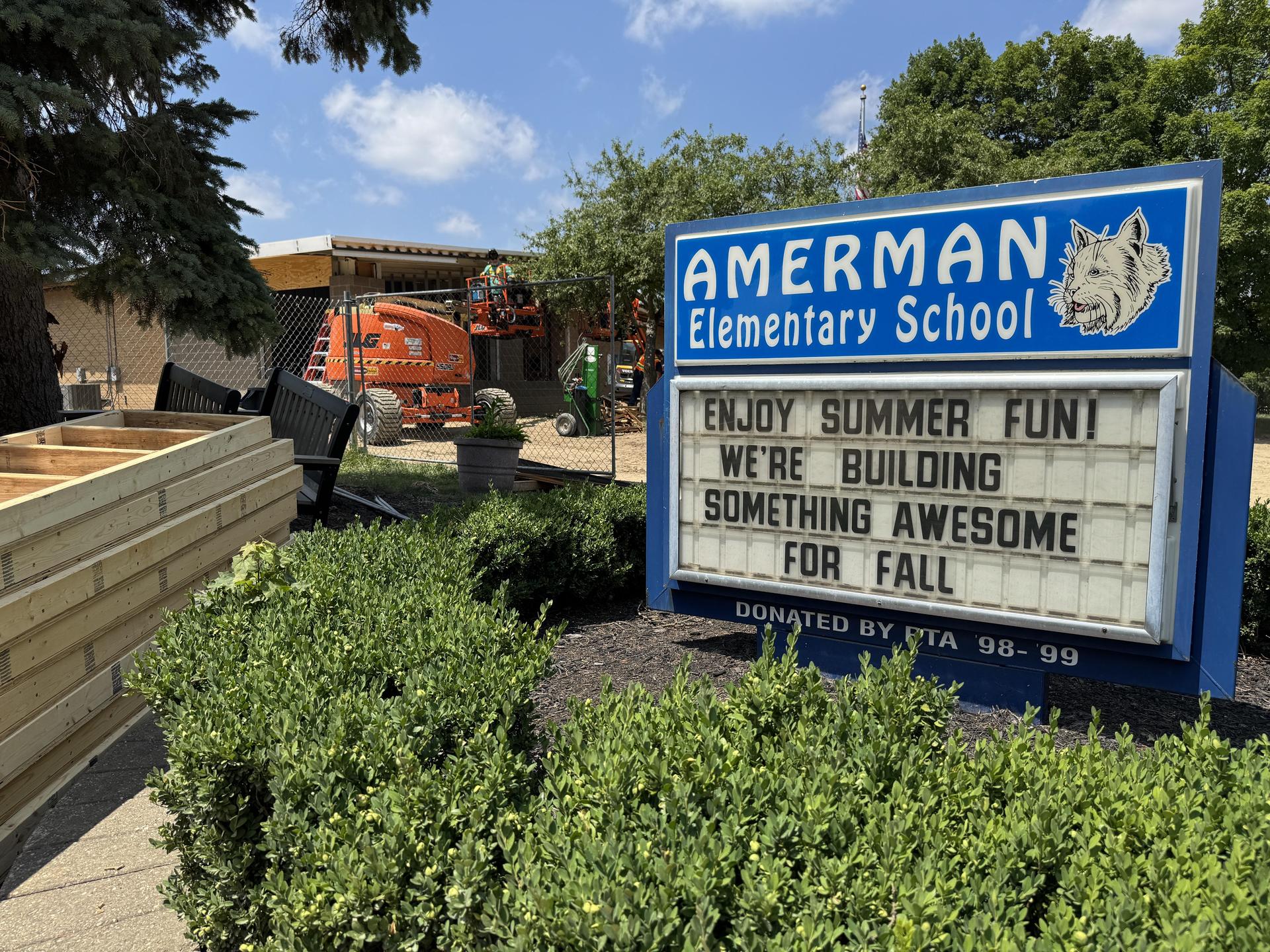 Amerman sign in front of building with construction happening in the background