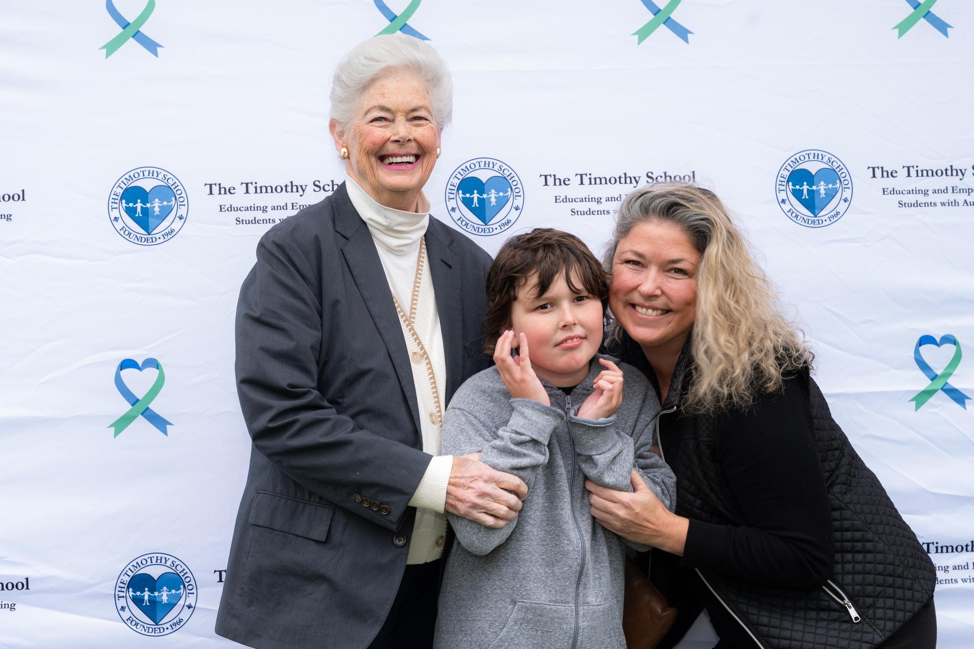 Three family members smiling.