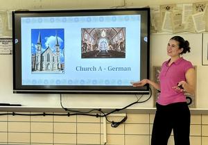 Student compares two churches, presenting images and information on a screen.