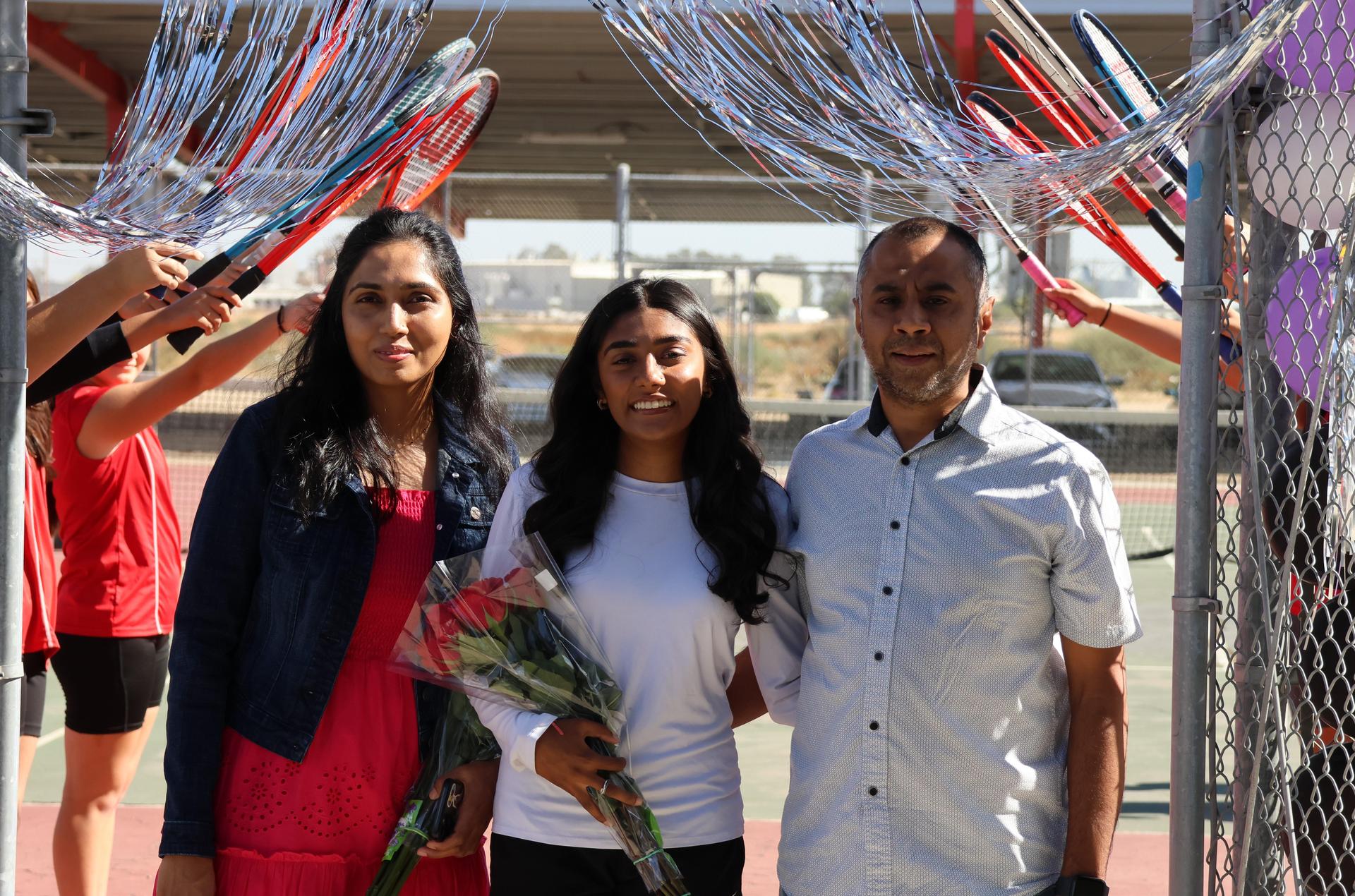 tennis players, family, and staff celebrating senior night