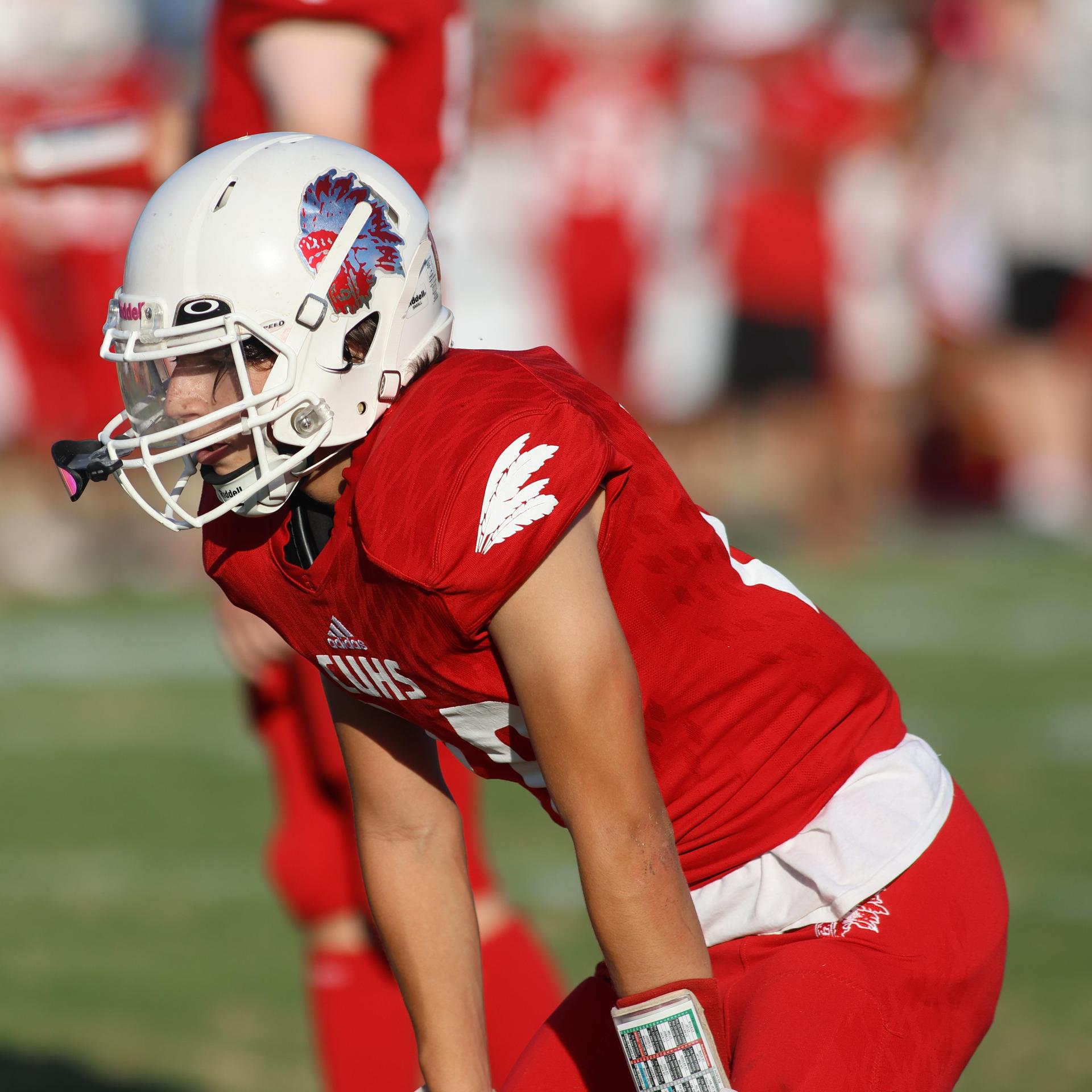 junior varsity football players in action against Fowler
