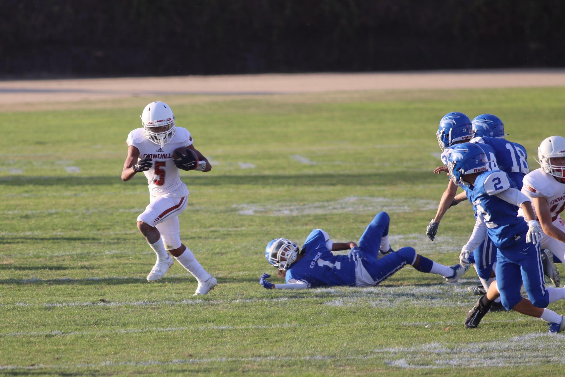 Junior Varsity football players in action against Caruthers