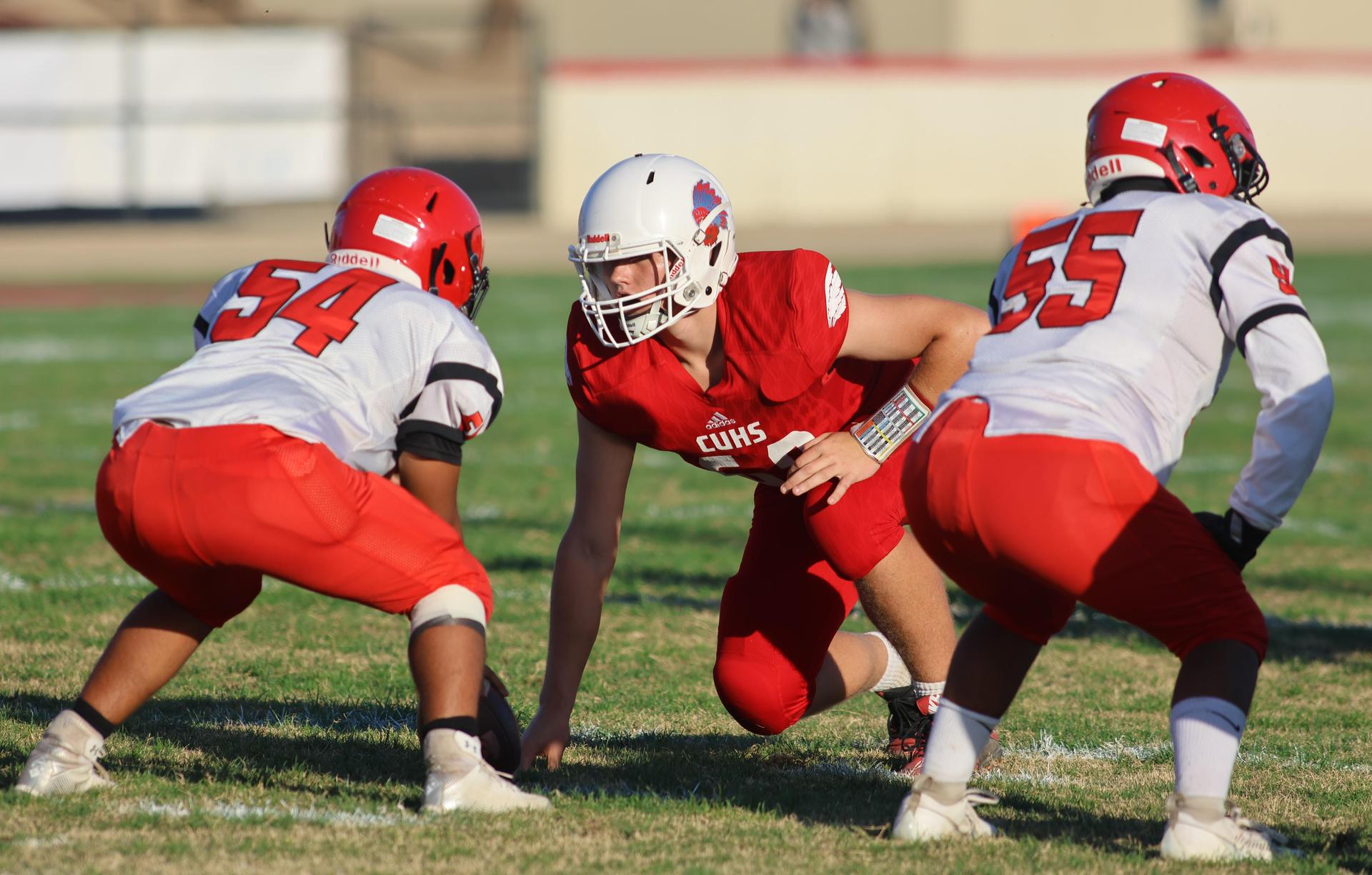 junior varsity football players in action against Fowler