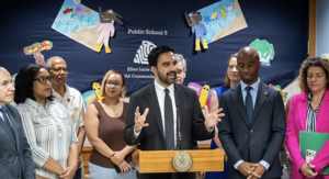 Mayor Mamdani stands with members of staff