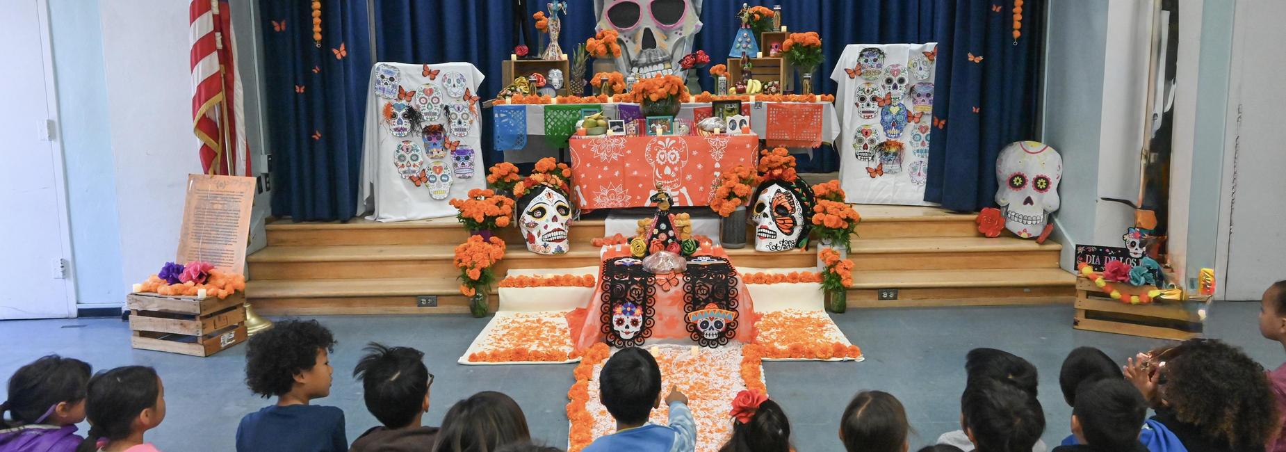 Students looking at Dia De Los Muertos alter.