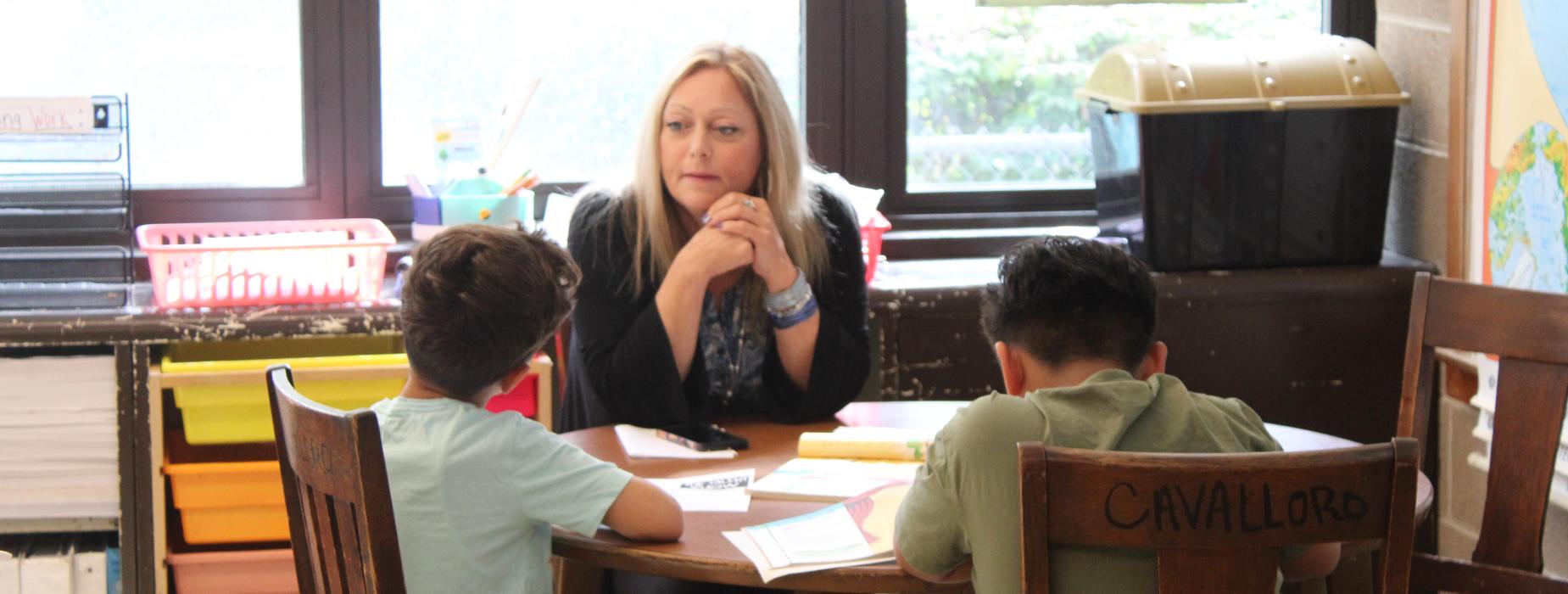 Teacher working with students in a small group of two
