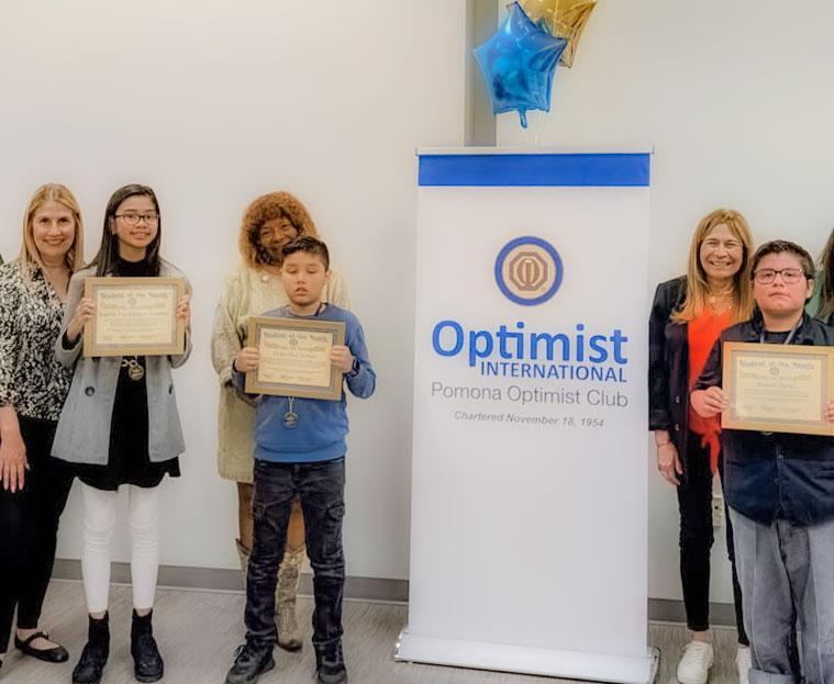 4 students with teachers at optimist booth