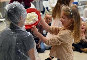a student tossing a pie into a teacher's face