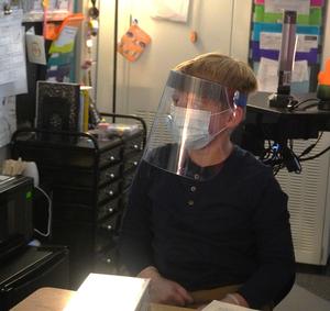 A student dons some protective healthcare attire.