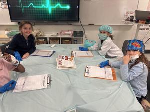 Second grade girls performing surgery on sentences.