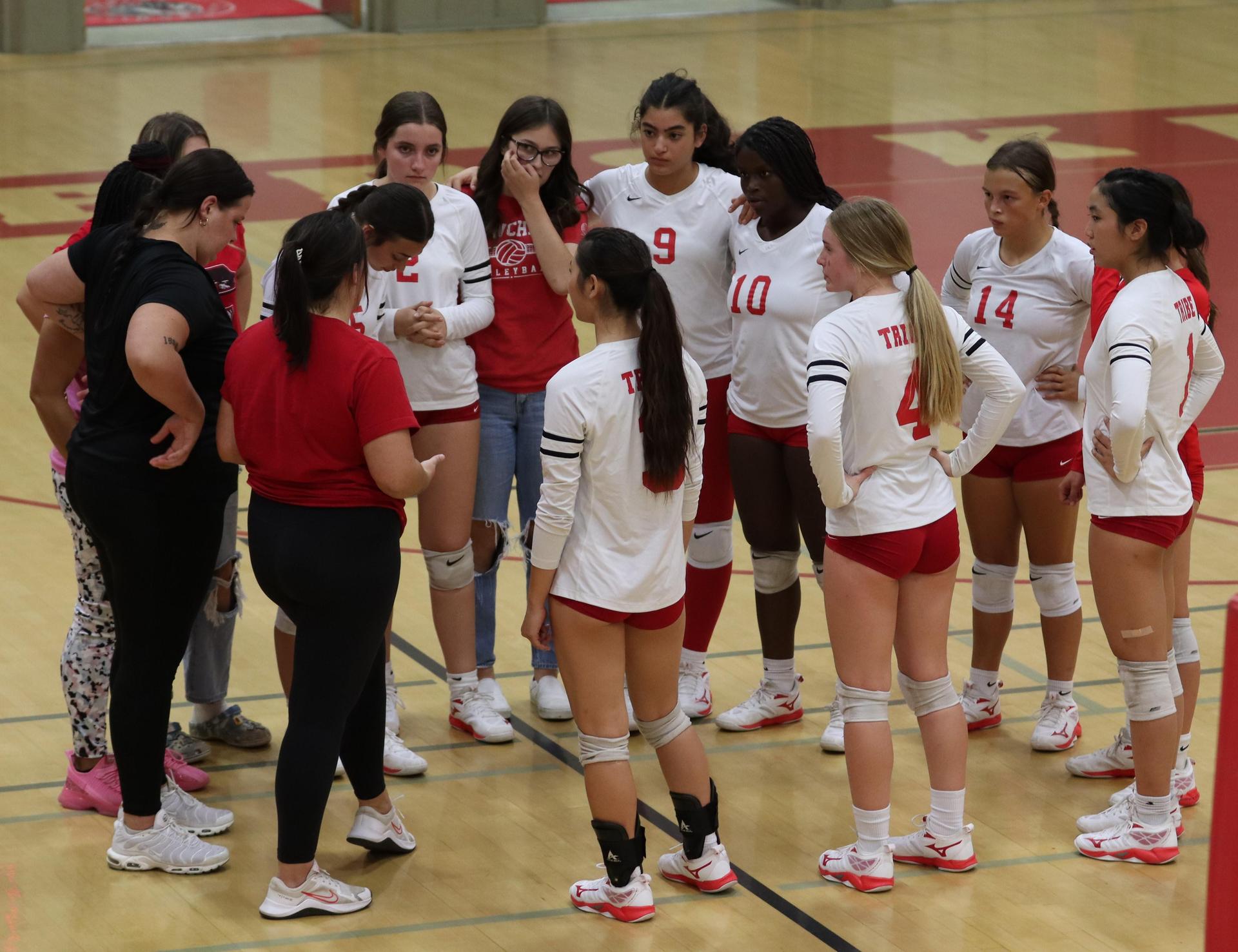 varsity volleyball players in action against Fresno Christian