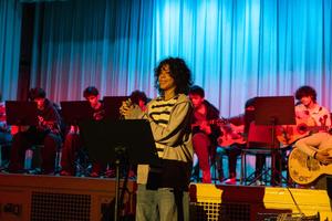 students on a stage performing with one in focus