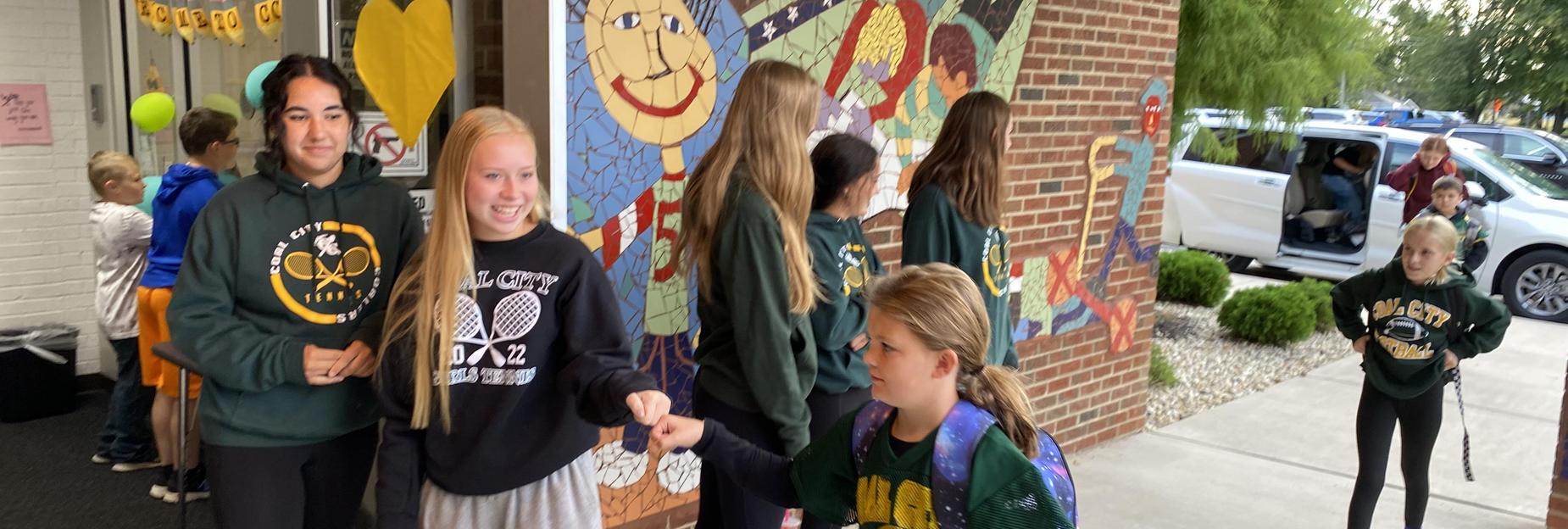 Tennis team greeting the IS students