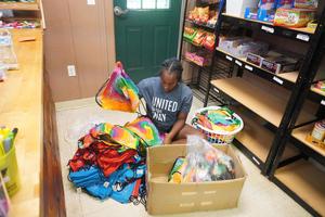 A student helps take inventory in the camp store.