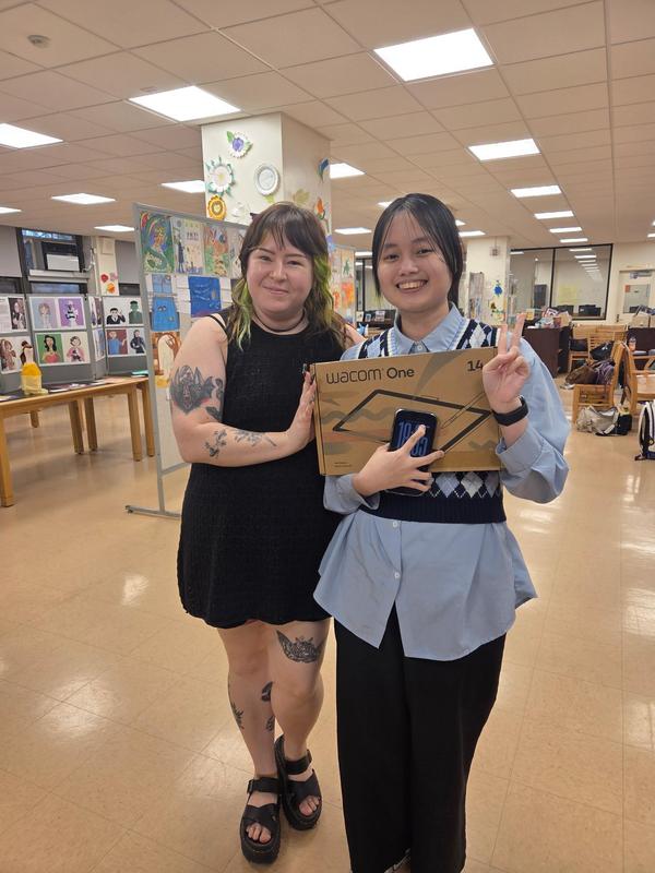 a teacher standing with student
