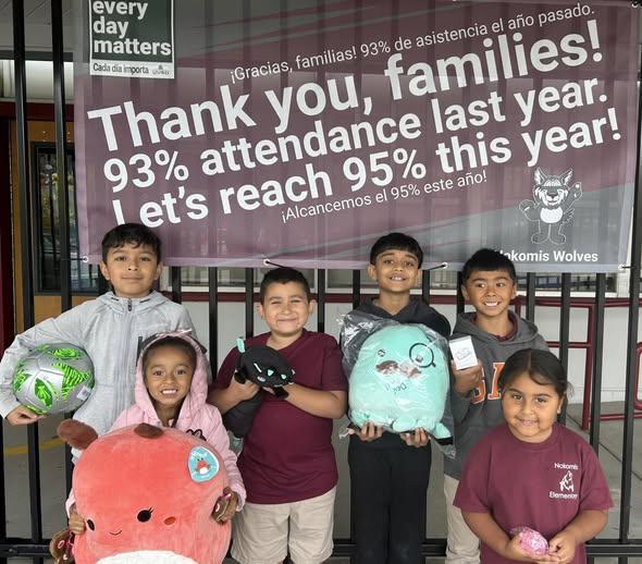 Students holding a toy