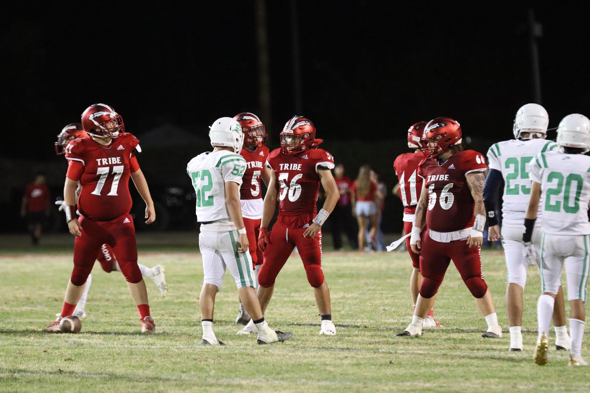 varsity football players in action against Riverdale