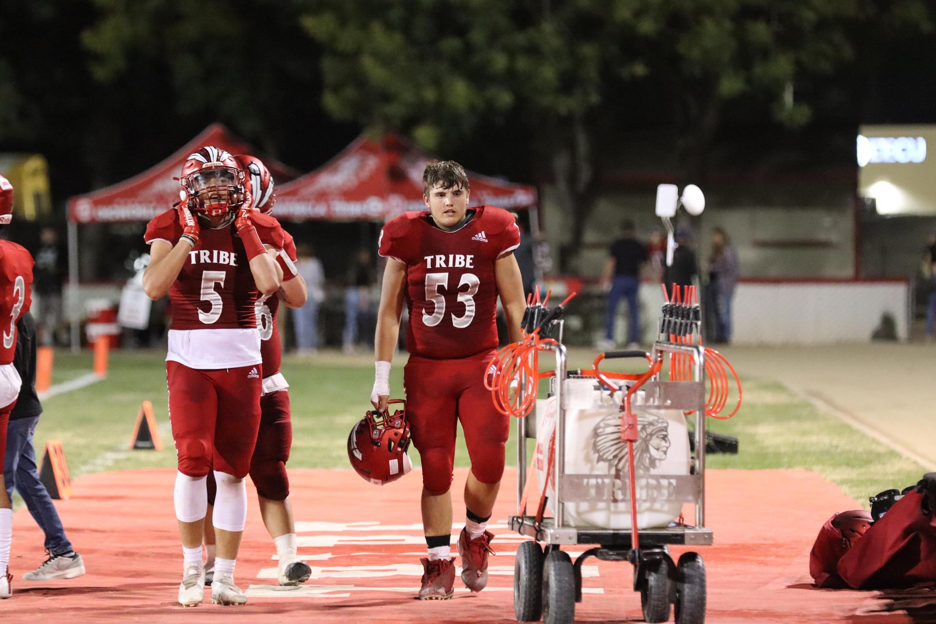 varsity football players in action against Riverdale