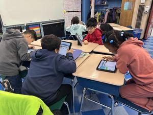 Students coding on laptops or ipads