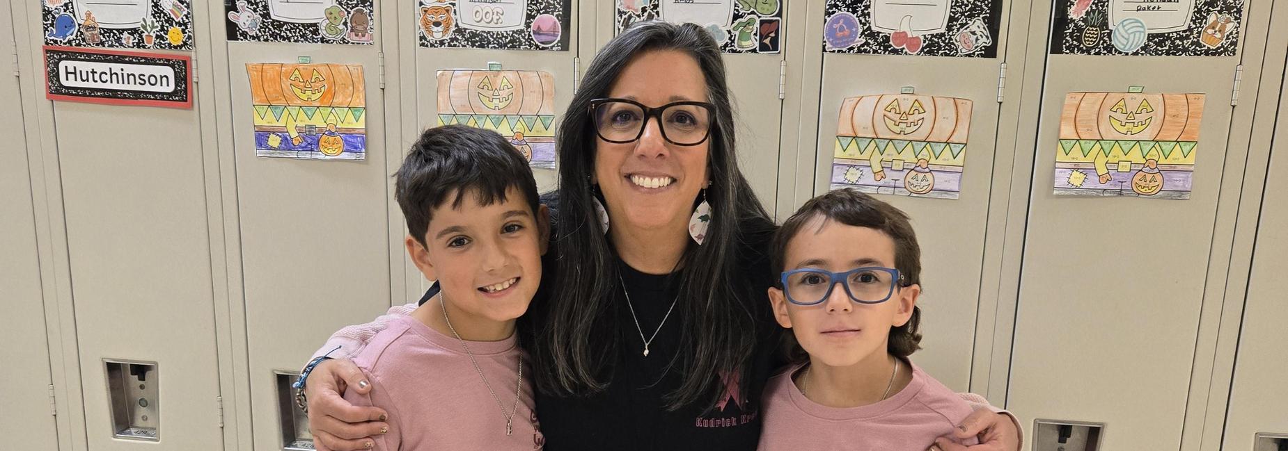 2 students and 1 adult wearing pink