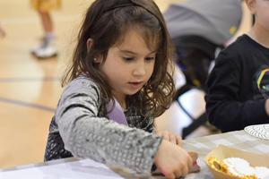 A girl doing a project at the fall festival