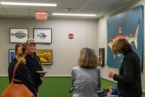 Student Discussing his work with parents and teachers
