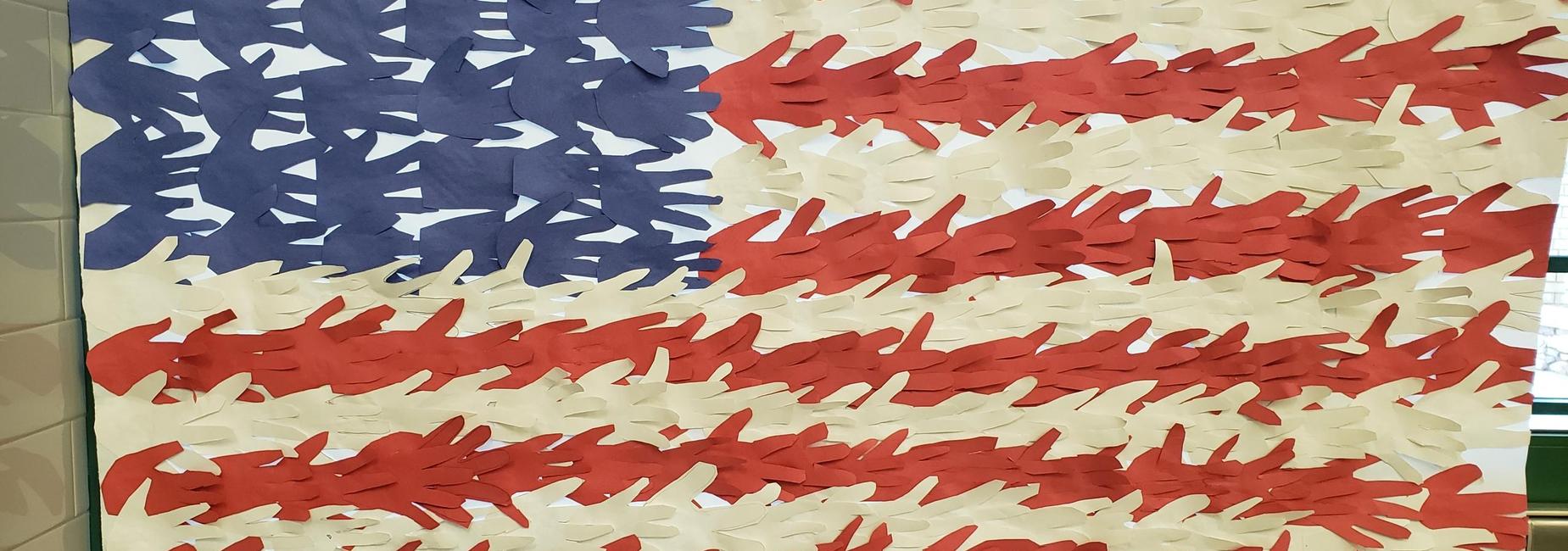 American flag made with student hand prints cut from red, white and blue paper
