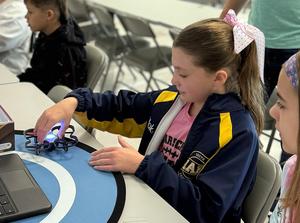 Students working with drones in a STEAM classroom.