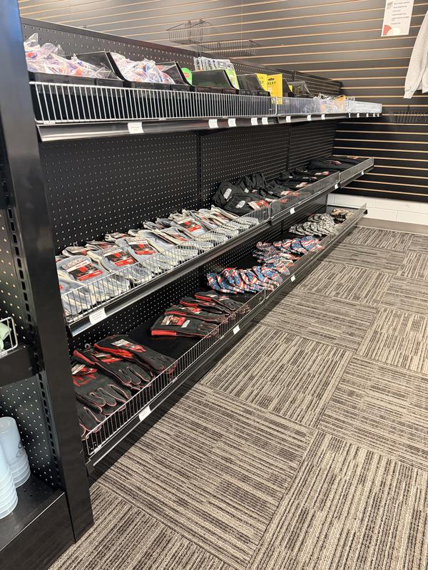 Shelves stocked with various tools and equipment in a retail store.
