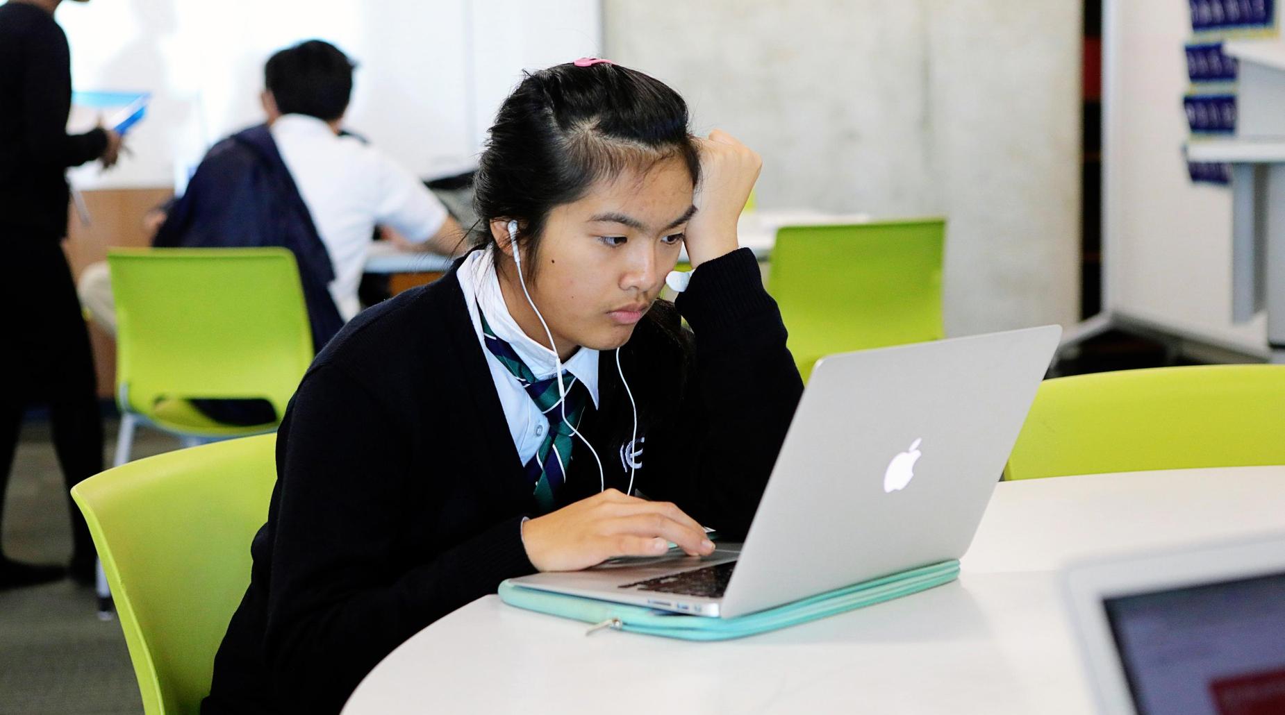 Scholar studying on her laptop
